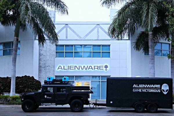 Alienware building with an truck and trailer in front