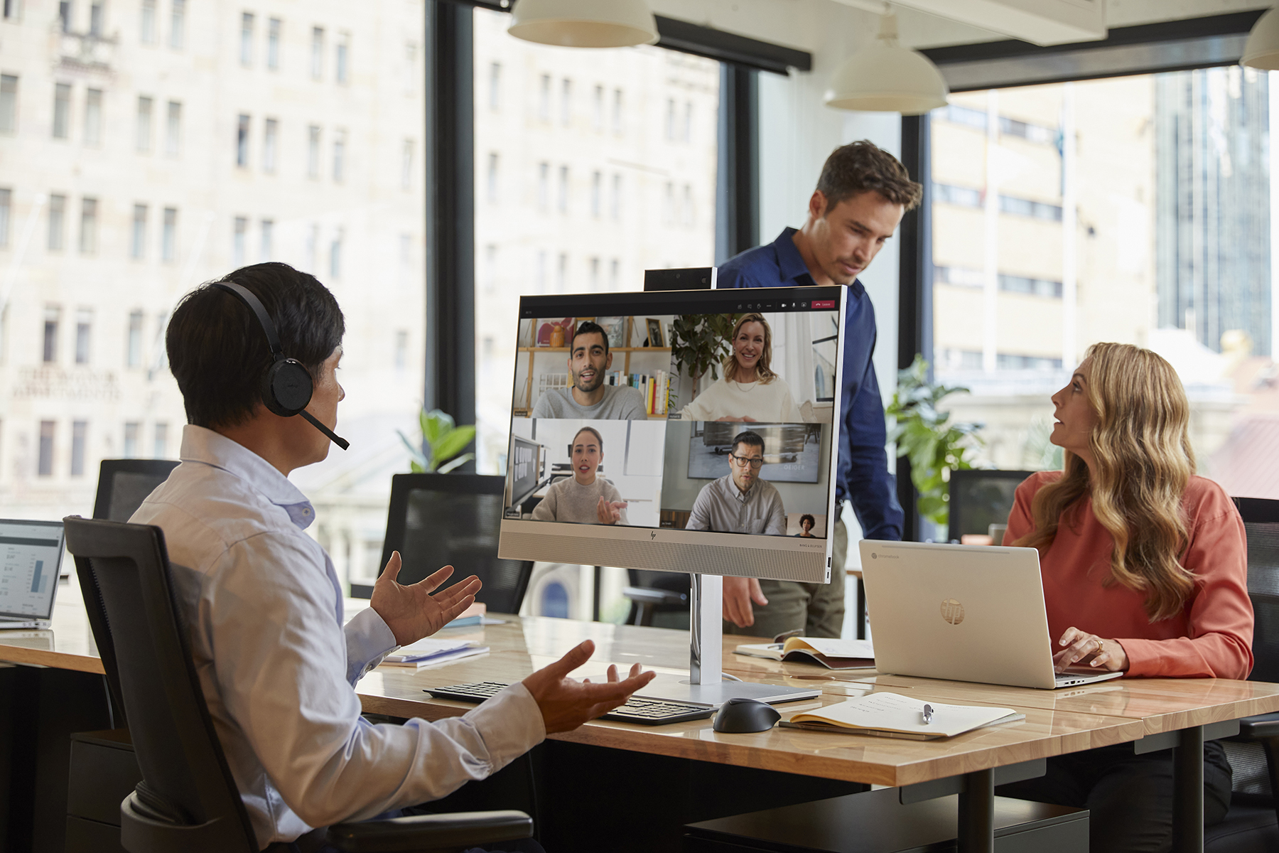 A person having a video conference while using the HP EliteOne 800 G8 All-in-One PC Workspace.