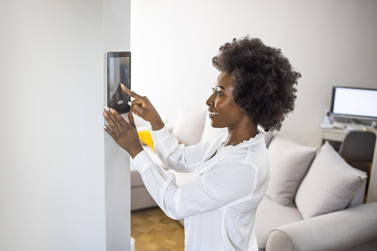 A woman turning her smart home to energy saving mode