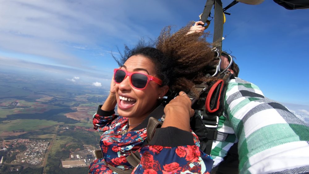a person using an action camera while skydiving