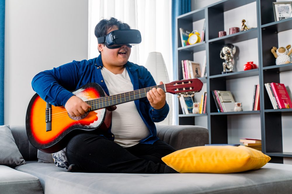 Boy using VR headset to play music