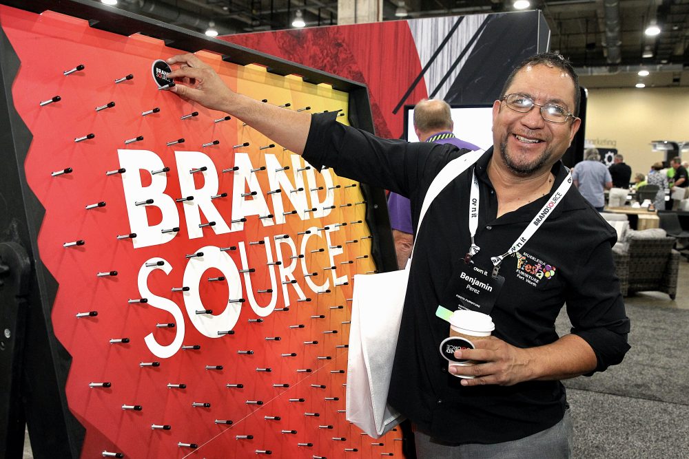 a person interacting with a booth at Brandsource