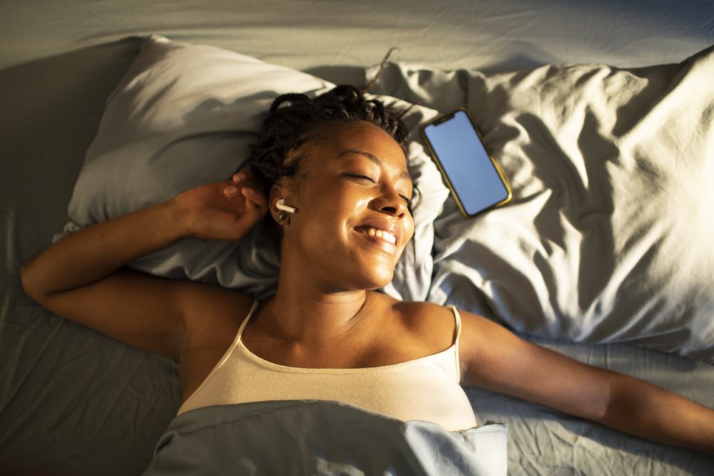 a women using audio tech to improve her sleep