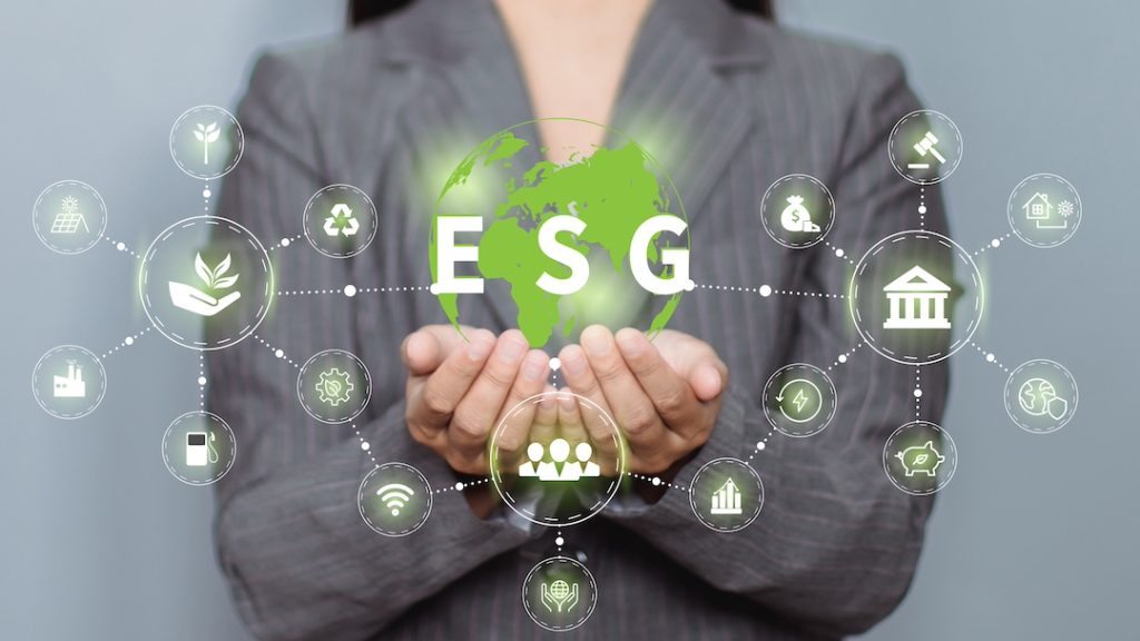 A concept image featuring a woman holding a green globe with interconnected icons depicting ESG and corporate sustainability.